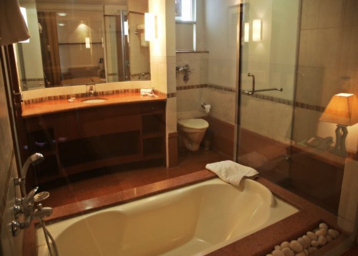 Bathroom with bathtub and glass cubicle shower at Osaka Serviced Apartments in Gurgaon